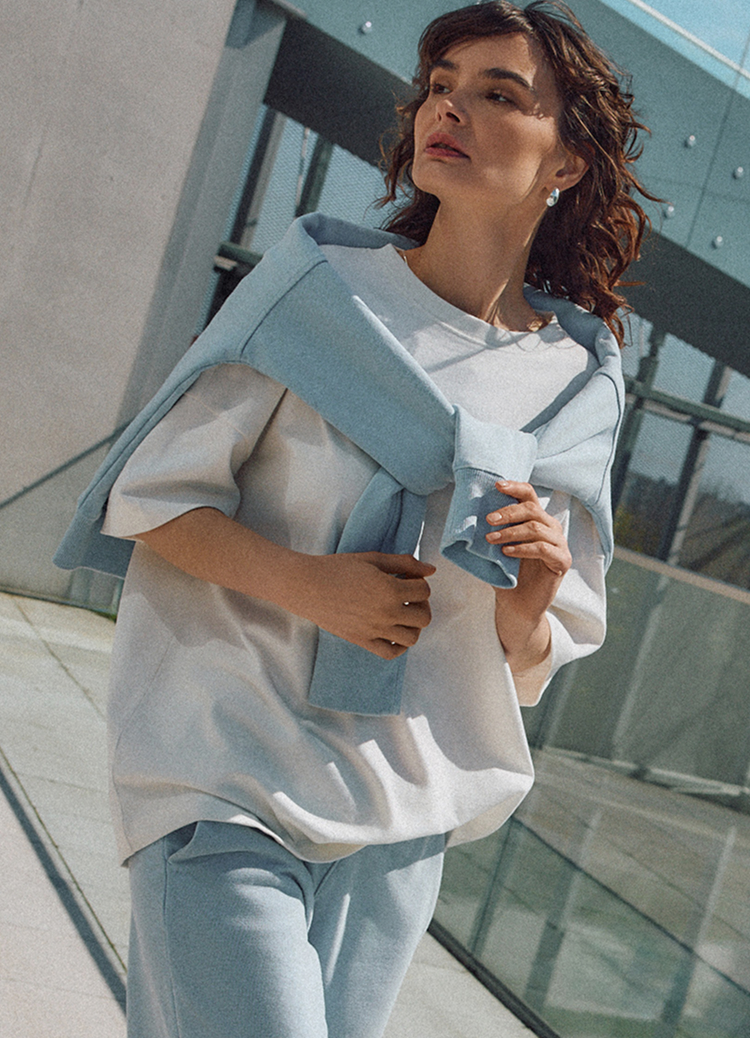 Casualowa stylizacja na co dzień, łącząca koszulkę z krótkim rękawem, luźne spodnie oraz lekką warstwę narzuconą na ramiona, zapewniająca komfortowy i nowoczesny wygląd.